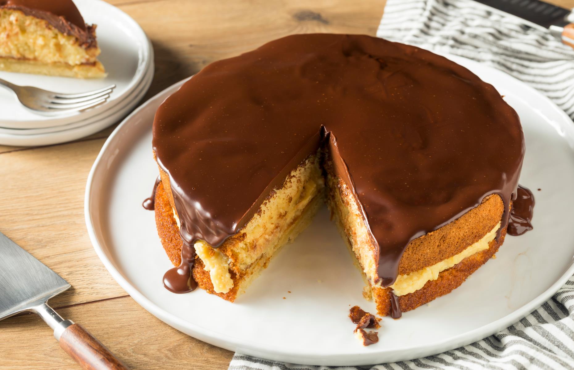 <p>The Boston cream pie is, in fact, a cake: a buttery yellow sponge filled with custard or cream and topped with chocolate icing. It’s <a href="https://boston.eater.com/2015/1/30/7949395/boston-cream-pie-history">claimed to have been invented</a> in 1856 at Boston’s Parker House (now Omni Parker House), with the hotel still serving its signature dessert. Pie and cake tins were often used interchangeably, so pies were often referred to as cakes and vice versa.</p>  <p><a href="https://www.lovefood.com/galleries/87278/the-best-pie-in-every-state?page=1"><strong>Find the best pie in your state here</strong></a></p>