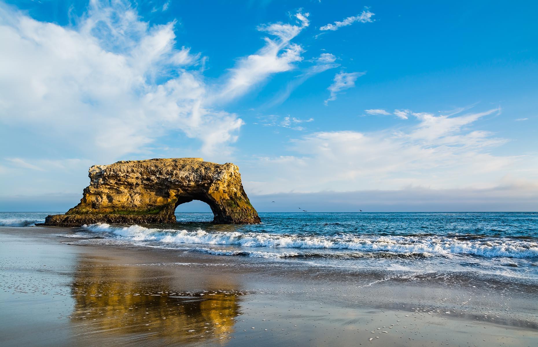 <p>Beyond the coastal city is even more natural beauty. Santa Cruz County is home to the largest number of state parks and beaches in California, with 14 in total. One of the most striking is the <a href="https://www.parks.ca.gov/?page_id=541">Natural Bridges State Park.</a> A wild landscape with one last sandstone arch rising from the sea, the 65-acre park is also a hot spot for monarch butterfly migrations, hosting up to 150,000 butterflies between October and early February.</p>