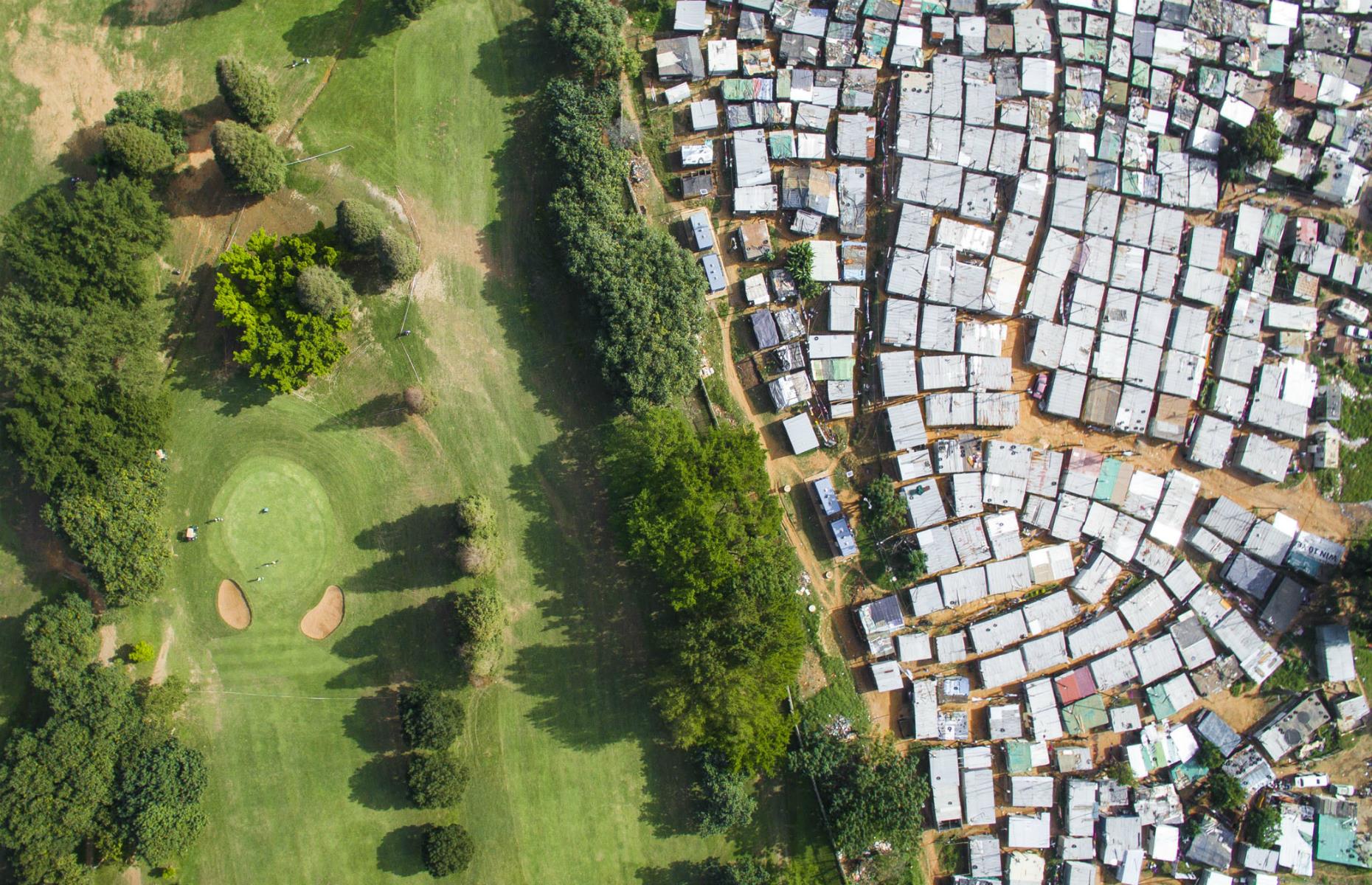 <p>This aerial view of Durban in South Africa shows how the Papwa Sewgolum Golf Course sits right next to a slum's tin shack homes. "In a twist of irony, the golf course is named after an Apartheid-era golfer of Indian descent, Sewsunker 'Papwa' Sewgolum," Miller told <em>the Telegraph</em> in a 2018 interview. "When he won the Natal Open in 1965, he had to receive his trophy outside, in the pouring rain, while the white players sat comfortably inside."</p>