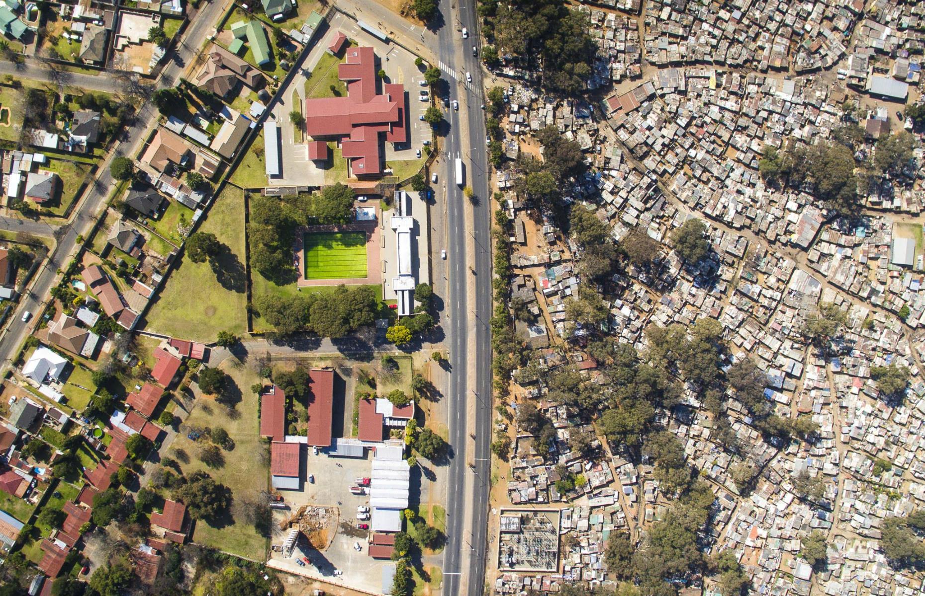 <p>This picture of the affluent Primrose area on the left and the Makause settlement in Johannesburg once again shows just a road separating extreme wealth from poverty. Sitting on an abandoned gold mine, the two places embody Apartheid, even 23 years after it was abolished. Primrose was named after the daughter of the British financier Barney Barnato in 1886, while Black Africans lived separately in Makause. Today, little has changed.</p>  <p><strong>These <a href="https://www.lovemoney.com/news/80106/11-cities-that-used-to-be-rich-but-are-now-poor">11 cities used to be rich but are now poor</a></strong></p>