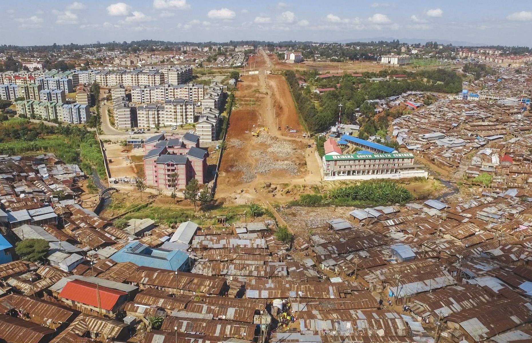 A road (pictured in its construction phase) is planned to cut through the Kibera slum, but this will only serve to displace thousands of those who call these tin and mud huts home.