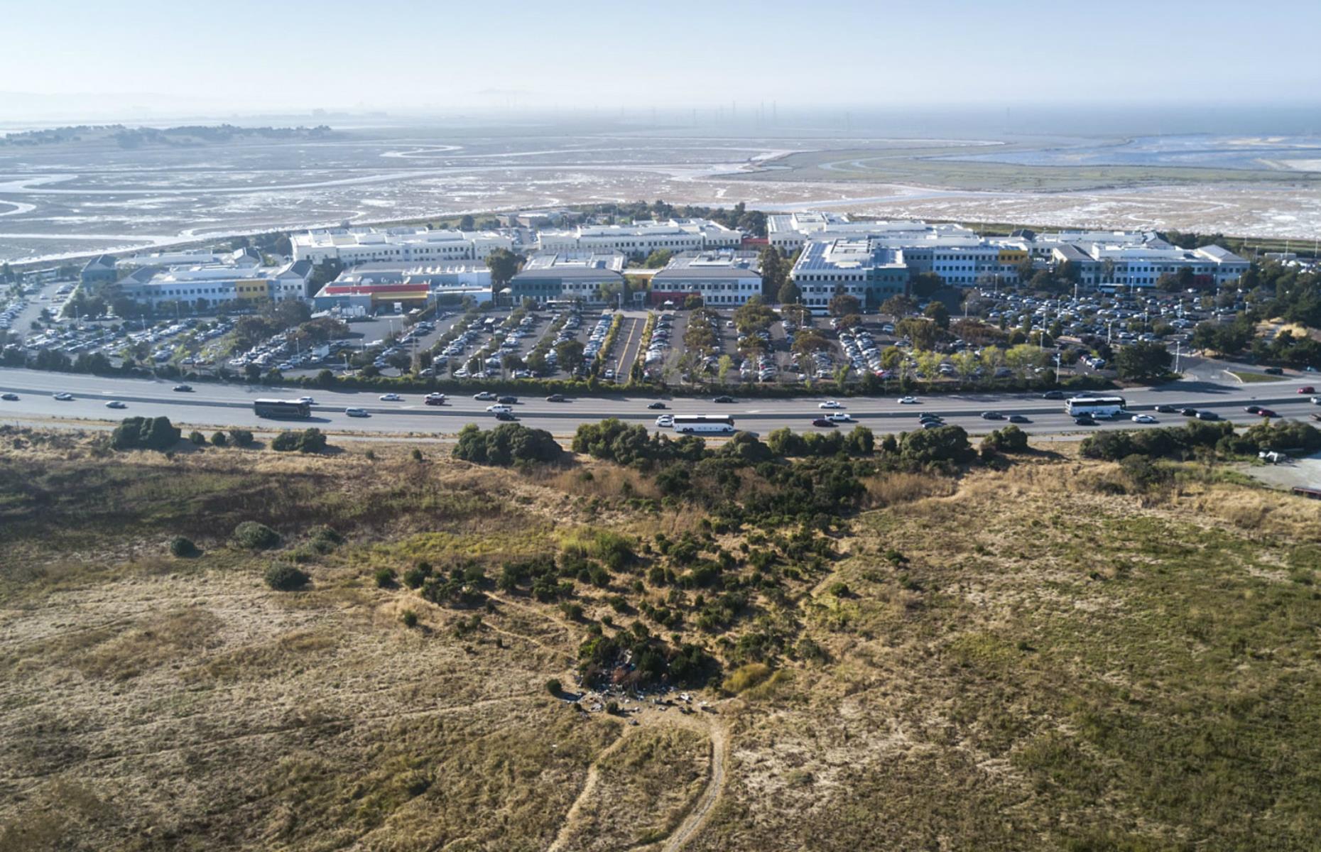 Silicon Valley has a problem with poverty. It may be the home to global multimillion-dollar companies, but it is far from a perfect scene. In this image in the foreground a patch of tents can be spotted sitting just across from Facebook's headquarters, a company currently valued at $725.5 billion (as of 17 September 2020).