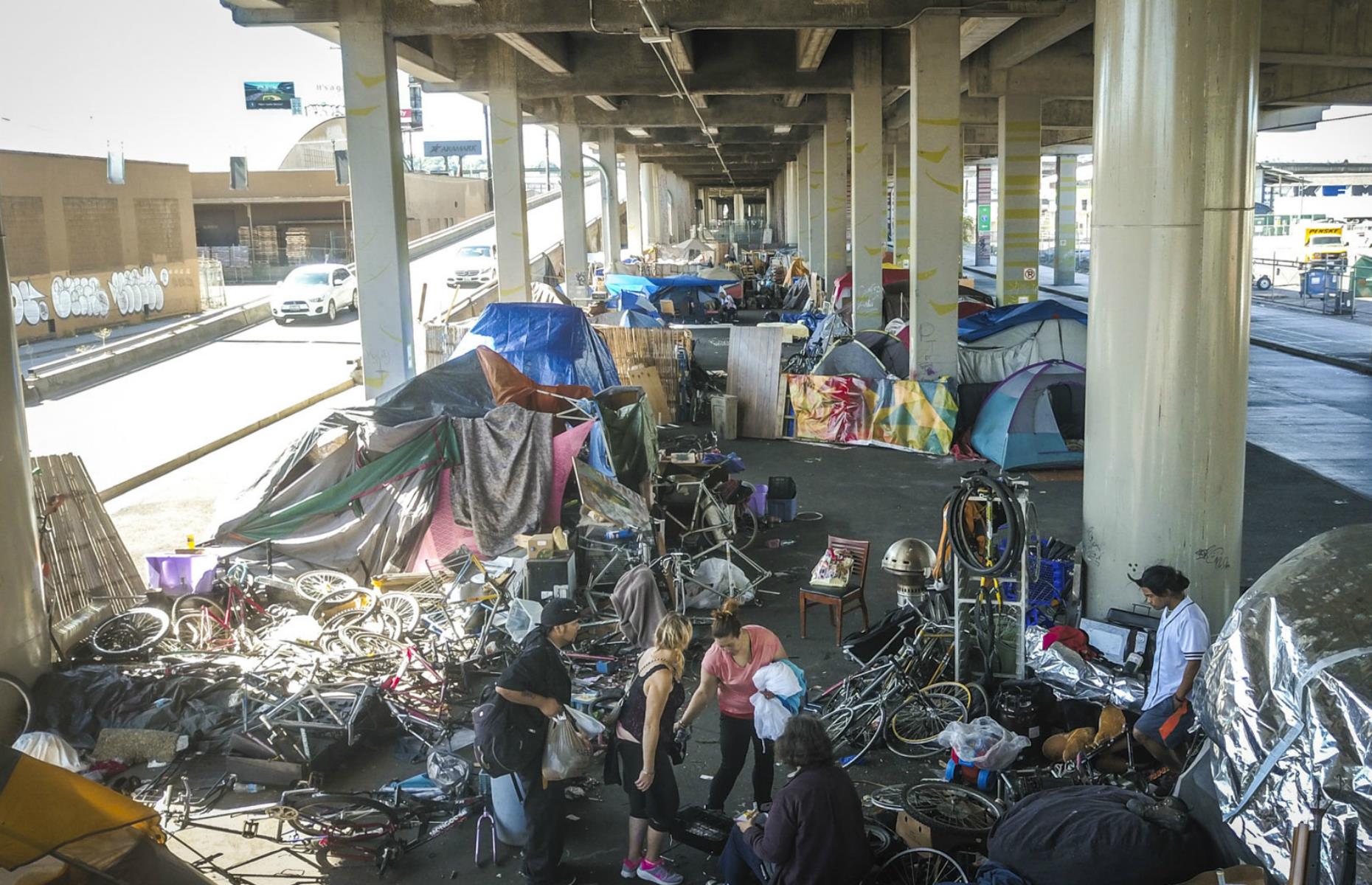 Often those living in tent cities have to move on when the government's lease on the space ends. This image was taken in the Alaskan Way Viaduct – a slightly more attractive site due to its roof protecting inhabitants from rain – days before it was slated to be closed. A sign threatened fines for not vacating.