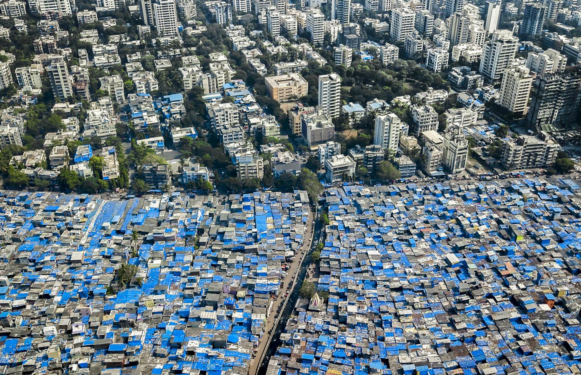 <p>Mumbai in India is densely packed with more than 20 million inhabitants. Not only that but the city has the largest slum population of any city in the world. In fact, as many as 43.1% of Mumbai's population lives in slums, according to the most recent census, similar to the one pictured, where blue tarpaulin is the only defence against the monsoon season. A study released recently has found that more than half of residents living in Mumbai's crowded slums have contracted coronavirus, where the disease has been spreading much faster than among richer parts of the population.</p>