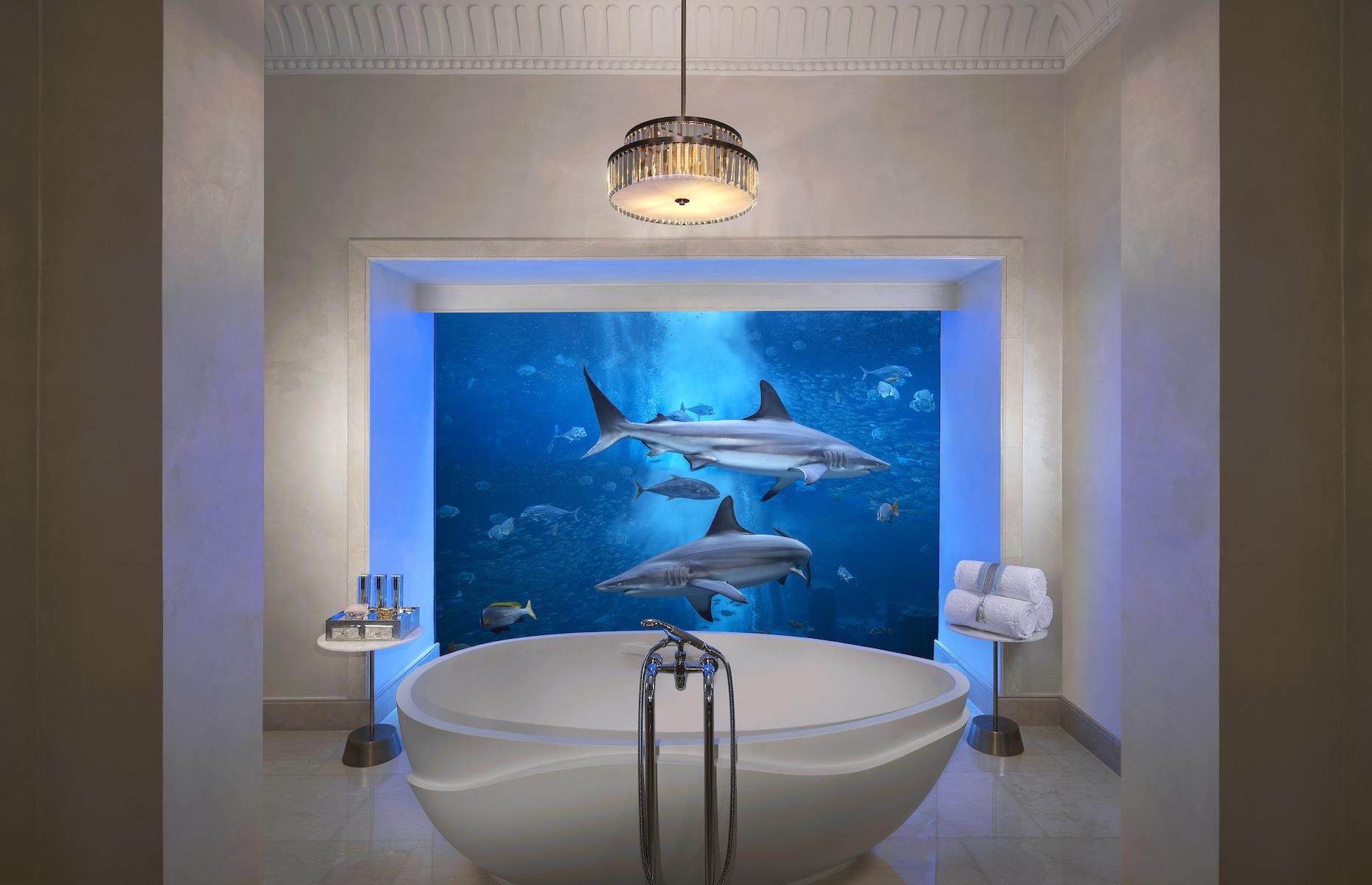 <p>The twin underwater suites – which come with a private butler – have above-ground lounges where guests can gaze out at the lagoon's lapping water. Down below, the bedrooms and bathrooms have soaring floor-to-ceiling windows onto the private marine oasis, allowing guests to stare at the entrancing scene as they wallow in the bed or marble bath. For those wishing to get even closer to their colorful neighbors, the suite includes entry into the aquarium which can also arrange tank dives (although due to current COVID-19 restrictions, dives are not currently on offer). </p>