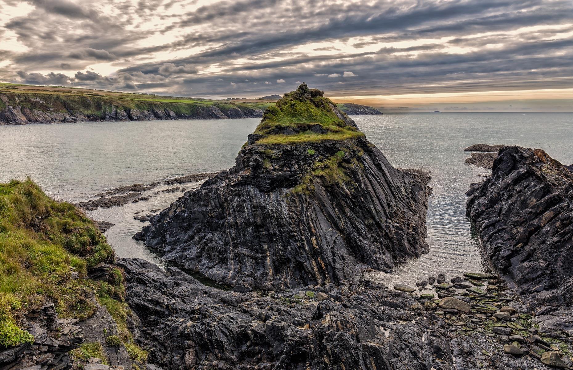 <p>Well worth a visit for the sheer beauty of the landscape, <a href="https://www.pembrokeshirecoast.wales/">Pembrokeshire Coast National Park</a> in Wales is also home to its fair share of fossils. Proving that bigger isn’t always better, this strip of British coastline boasts thousands of tiny graptolites frozen in its ancient rocks, many of which can be found on Abereiddy Bay beach. These minute creatures actually predate dinosaurs and existed over 400 million years ago. The perfect place to head for a spot of fossil hunting, the area's spectacular coastal path is not to be missed.</p>