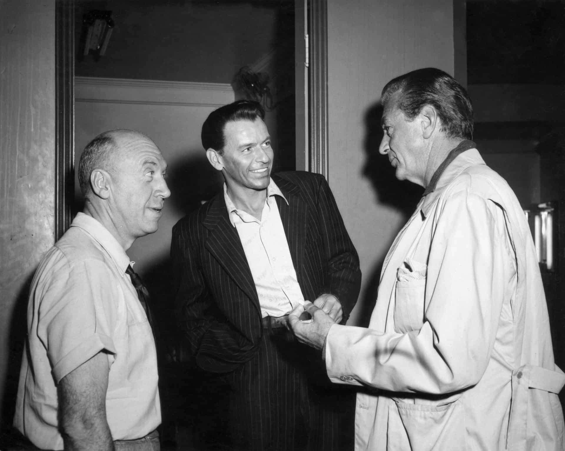 Der in Österreich geborene Regisseur Otto Preminger (links) mit Sinatra und Gary Cooper (rechts) am Set von Premingers Film "Der Mann mit dem goldenen Arm".
