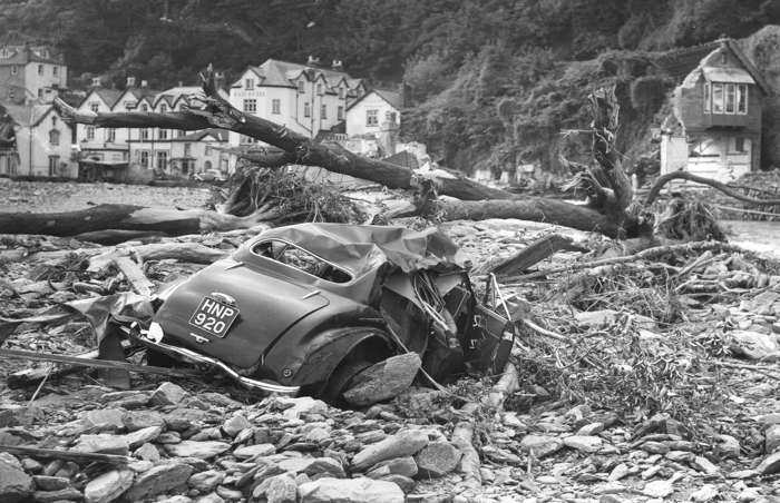 27 of 64 Photo in Gallery: The residents of Lynmouth, north Devon had been experiencing an exceptionally rainy summer when an enormous wave tore their community apart. On the night of 15 August 1952, after nine inches (23cm) of rain fell in 24 hours, a destructive wall of water surged down a narrow valley from Exmoor, uprooting trees and boulders on its way. Buildings and bridges were obliterated and cars were swept away to sea. Thirty-four people also lost their lives in the disaster.