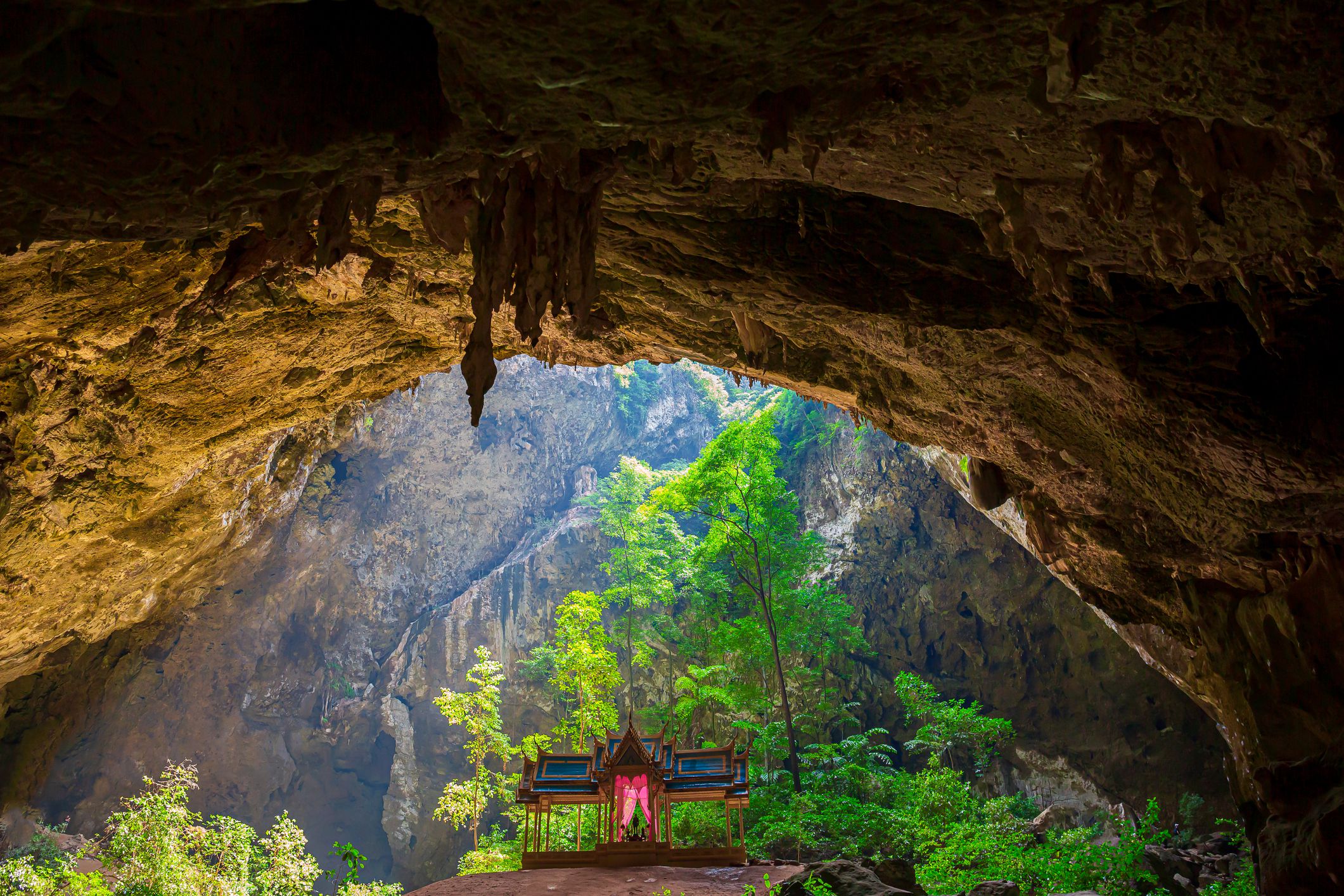 Slide 17 of 52: Located in Khao Sam Roi Yot National Park in Thailand, this cave has a small golden pavilion hidden within its recesses.   
