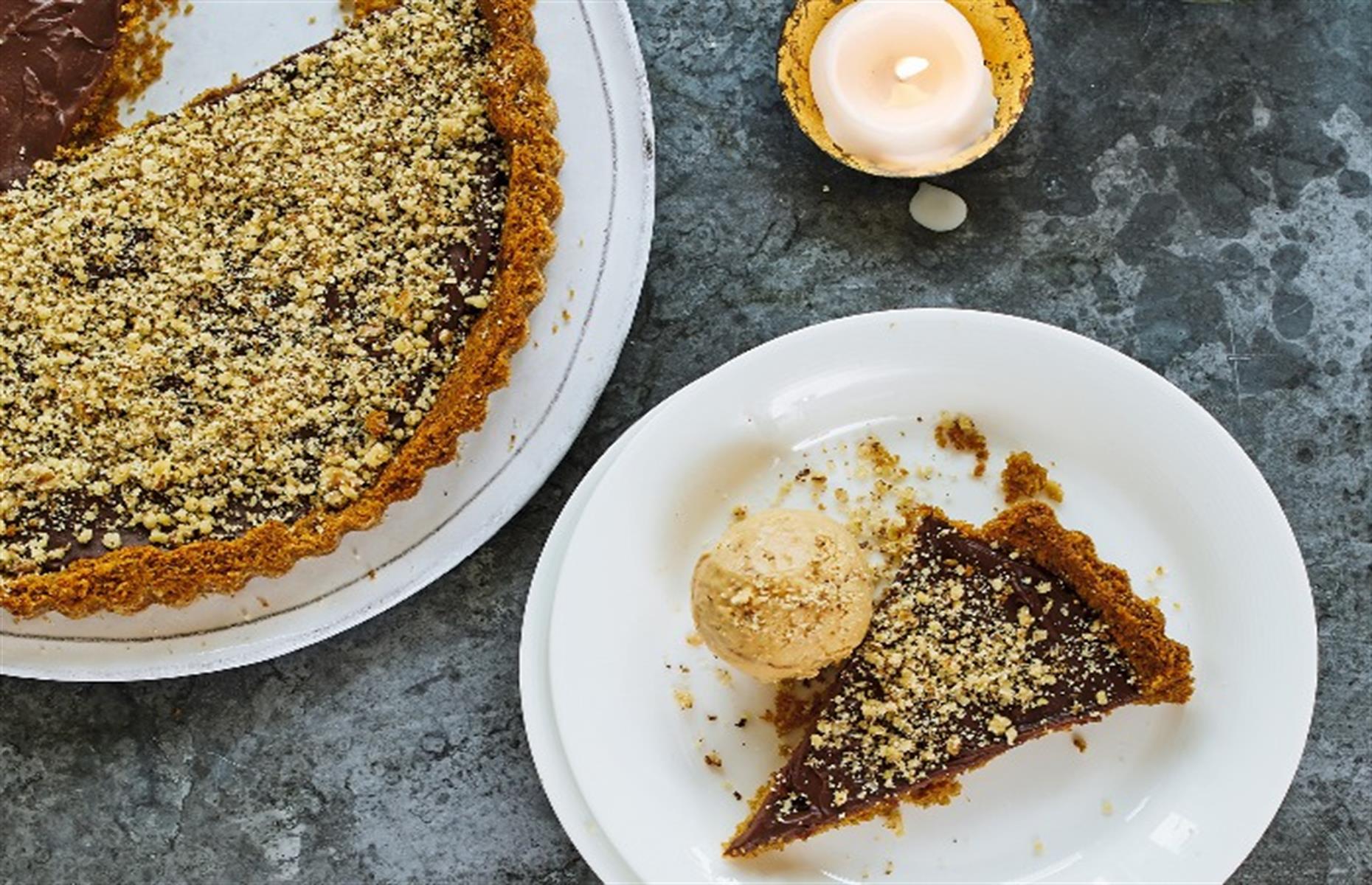 Slide 22 of 31: This Greek recipe has a base of cookie dough, which is drenched in a honey syrup, then filled with a dark chocolate cream. It takes a bit of effort, but it's well worth it. It's covered with crushed walnuts, then served with a hazelnut ice cream, but you can just buy your favorite ice cream to go with it. Coffee flavor would be perfect. Get the recipe for chocolate ganache tart here