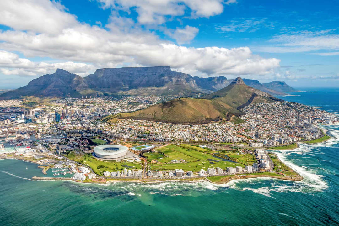 Slide 20 of 58: South Africa, the southernmost country in Africa, is appreciated for its wines,&nbspwildlife, and cities like Cape Town (pictured), situated beneath the landmark Table Mountain.
