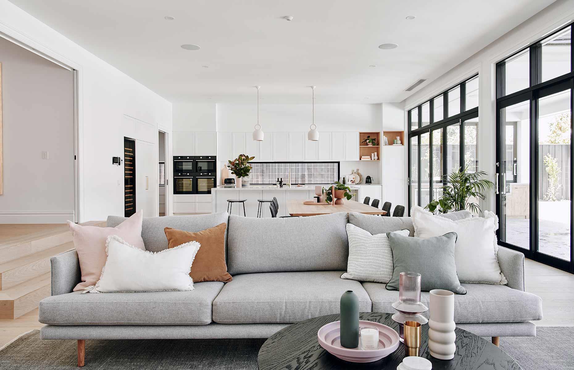 Use furniture to zone off an airy open-plan space in need of structure. This modern living area is divided into thirds thanks to carefully arranged fixtures – the breakfast bar separates the kitchen and dining zones, while the sofa creates an intimate seating nook that’s distanced from the busy culinary space.