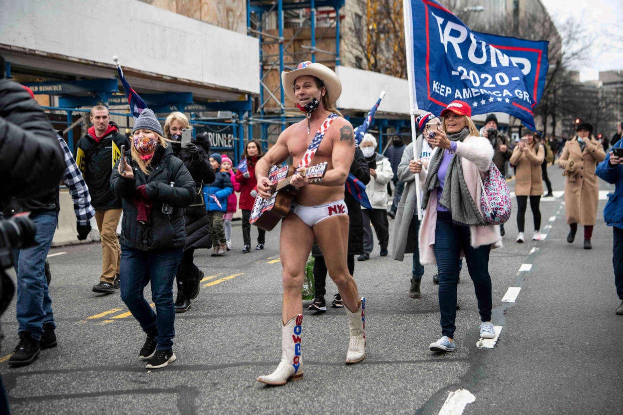 Slide 63 of 76: Robert John Burck, also known as the Naked Cowboy, sings and marches towards the Washington Monument in Washington, D.C. as the U.S. Congress meets to formally ratify Joe Biden as the winner of the 2020 Presidential election on Jan. 6, 2021.