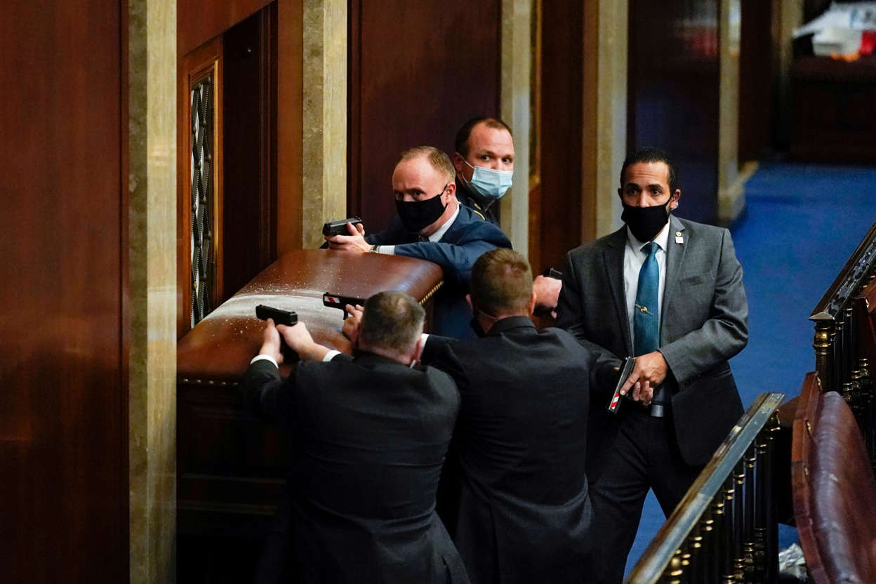Slide 15 of 76: Capitol police guard a barricaded door as protesters try to break into the House chamber at the U.S. Capitol on Jan. 6.