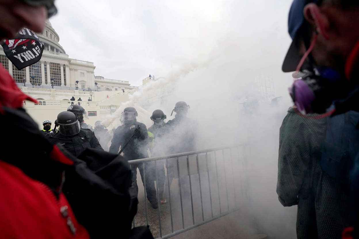 Slide 45 of 76: Trump supporters try to break through a police barrier, Jan. 6, 2021, at the Capitol in Washington.