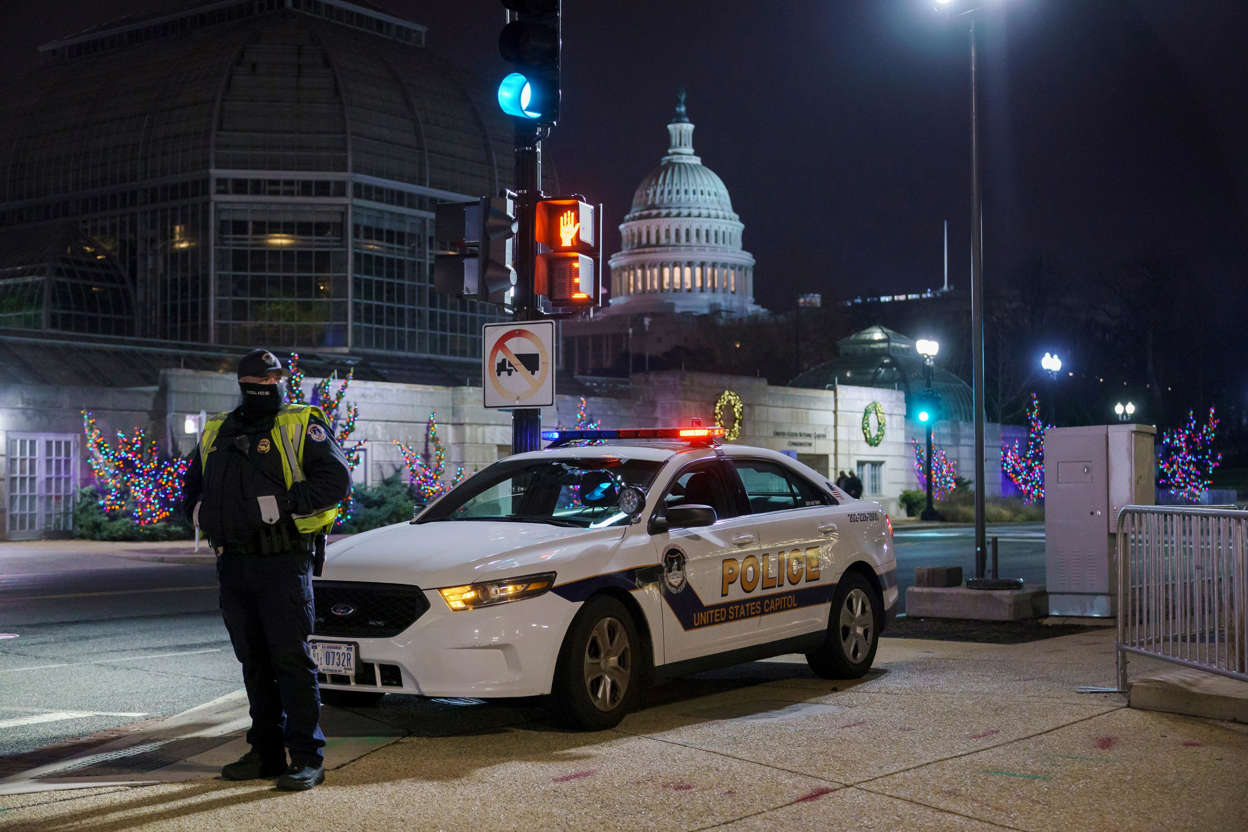 Slide 74 of 76: A U.S. Capitol Police officer stands watch on Independence Avenue before dawn as the House and Senate prepare to convene a joint session to count the electoral votes cast in November's election, on Capitol Hill in Washington, Jan. 6, 2021.