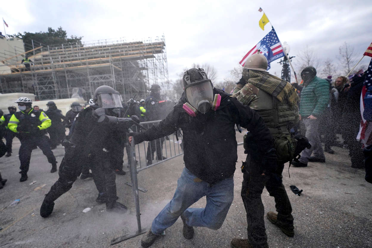 Slide 46 of 76: Trump supporters try to break through a police barrier, Jan. 6, 2021, at the Capitol in Washington.