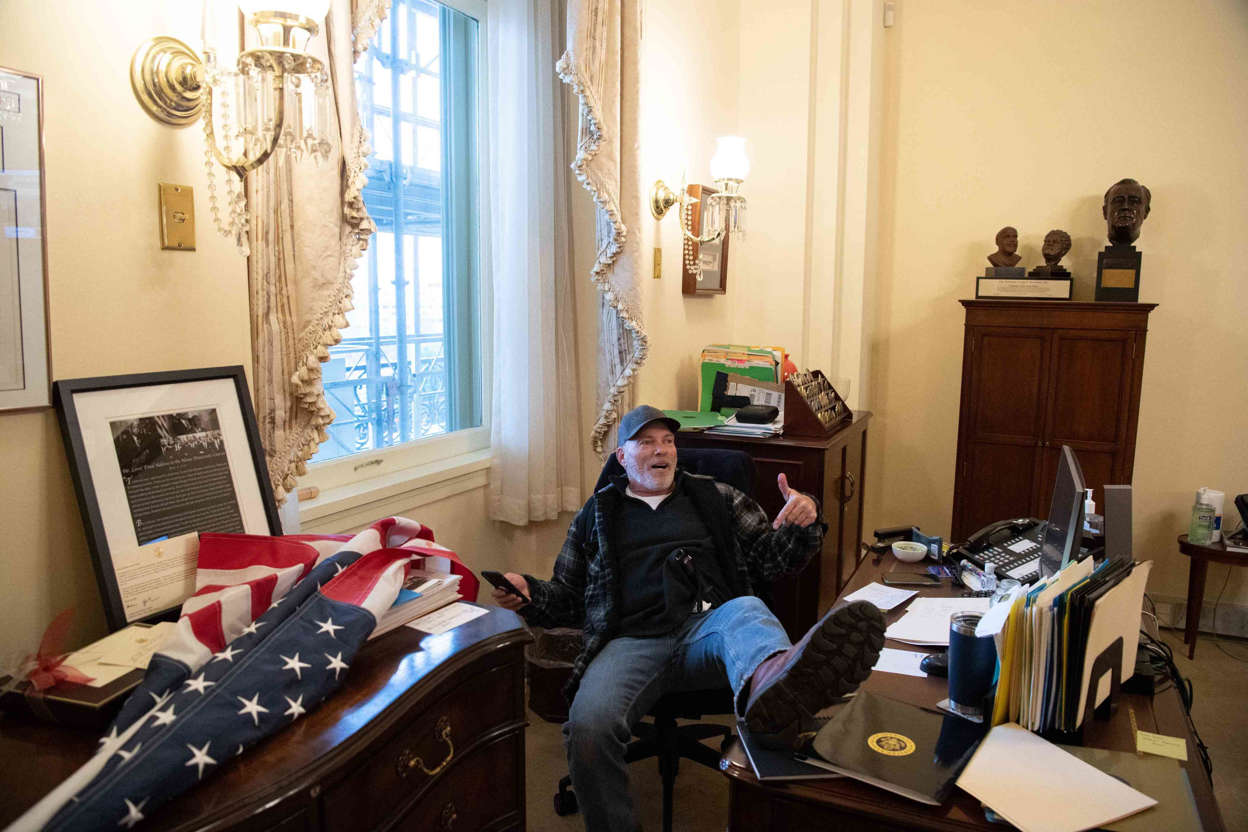 Slide 8 of 76: A supporter of President Donald Trump sits inside the office of U.S. Speaker of the House Nancy Pelosi inside the U.S. Capitol in Washington, D.C., on Wednesday, Jan. 6, 2021.