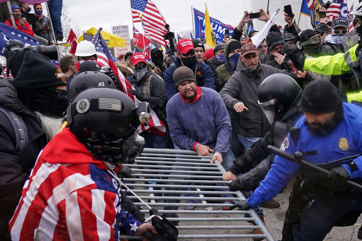 Slide 42 of 76: Trump supporters try to break through a police barrier, Wednesday, Jan. 6, 2021, at the Capitol in Washington. As Congress prepares to affirm President-elect Joe Biden's victory, thousands of people have gathered to show their support for President Donald Trump and his claims of election fraud.