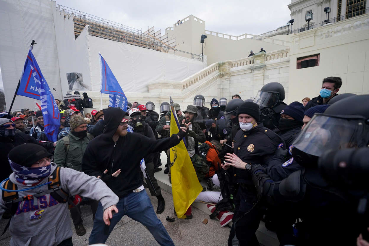 Slide 43 of 76: Trump supporters try to break through a police barrier, Jan. 6, 2021, at the Capitol in Washington.