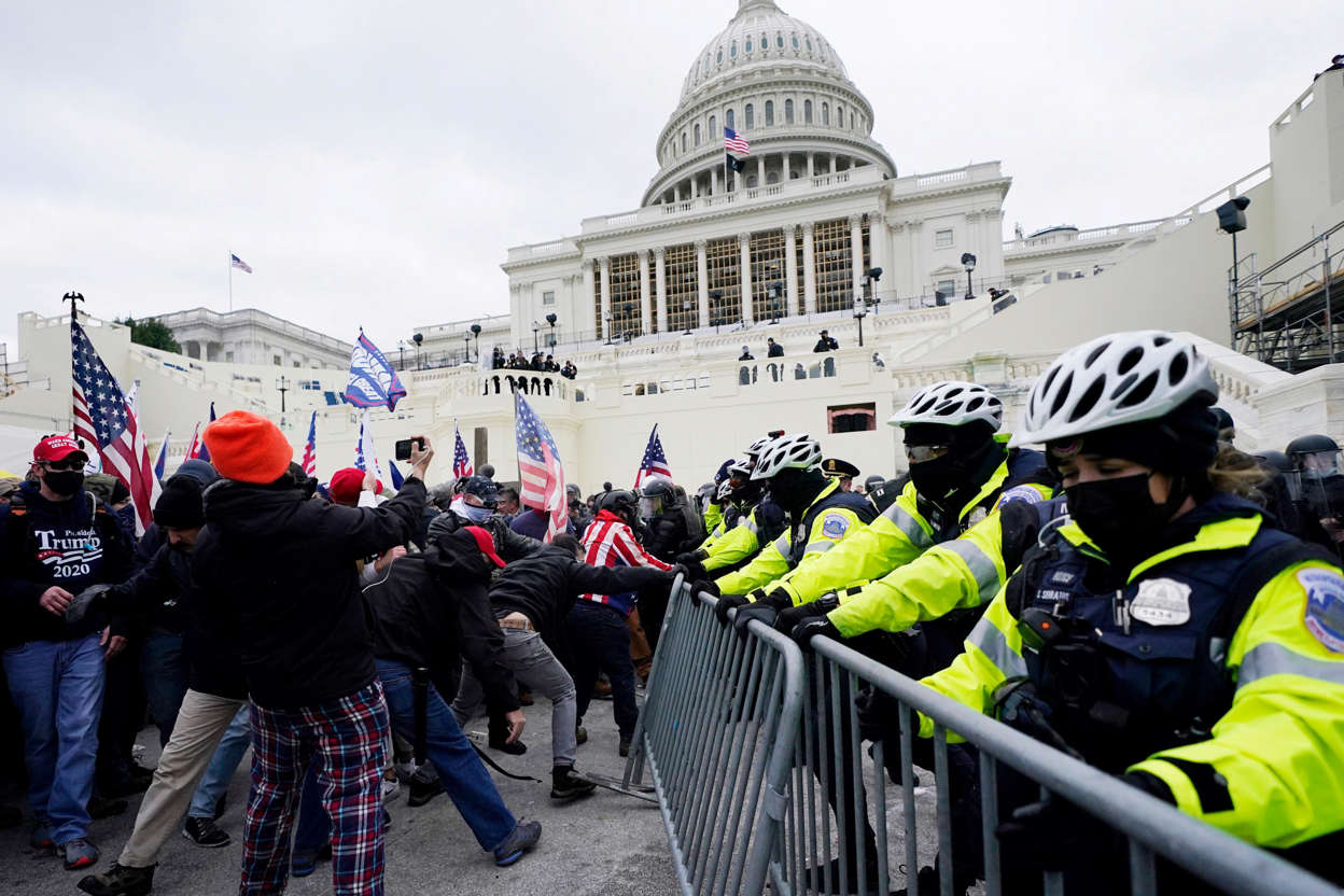 Slide 44 of 76: Trump supporters try to break through a police barrier, Jan. 6, 2021, at the Capitol in Washington. As Congress prepares to affirm President-elect Joe Biden's victory, thousands of people have gathered to show their support for President Donald Trump and his claims of election fraud.