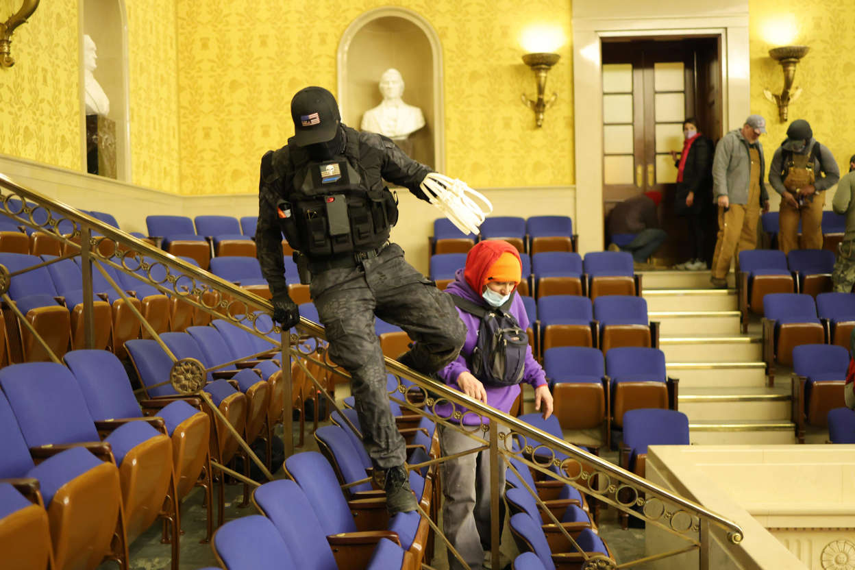 Slide 14 of 76: Rioters enter the Senate chamber on Jan. 6, 2021, in Washington, D.C.