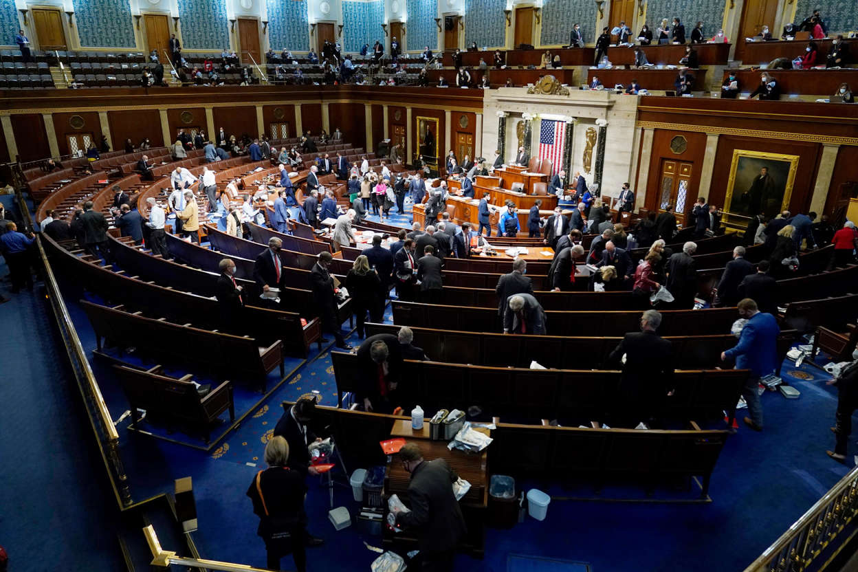 Slide 36 of 76: House members prepare to leave the floor as protesters try to break into the House Chamber at the U.S. Capitol on Wednesday, Jan. 6, 2021, in Washington.