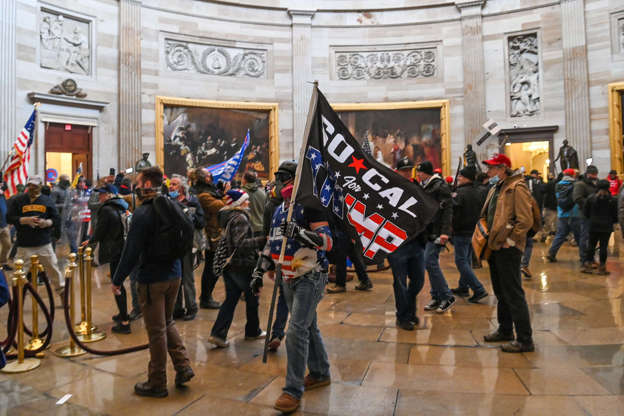 Slide 2 of 12: Supporters of US President Donald Trump roam under the Capitol Rotunda after invading the Capitol building on January 6, 2021, in Washington, DC. - Demonstrators breeched security and entered the Capitol as Congress debated the a 2020 presidential election Electoral Vote Certification.