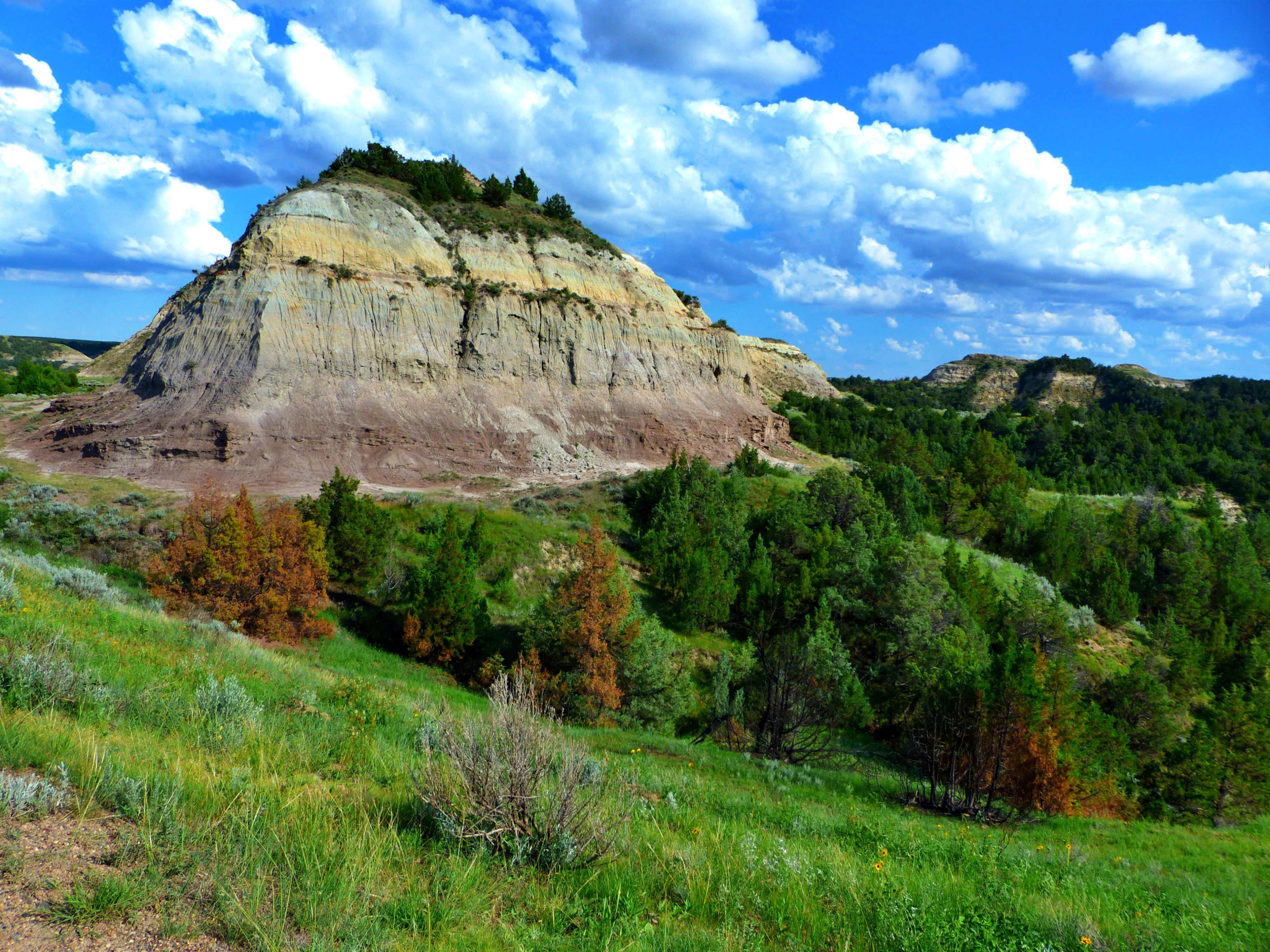 ����� 3 �� 34: A colorful butte rises from the badland landscape of North Dakota's Theodore Roosevelt National Park.