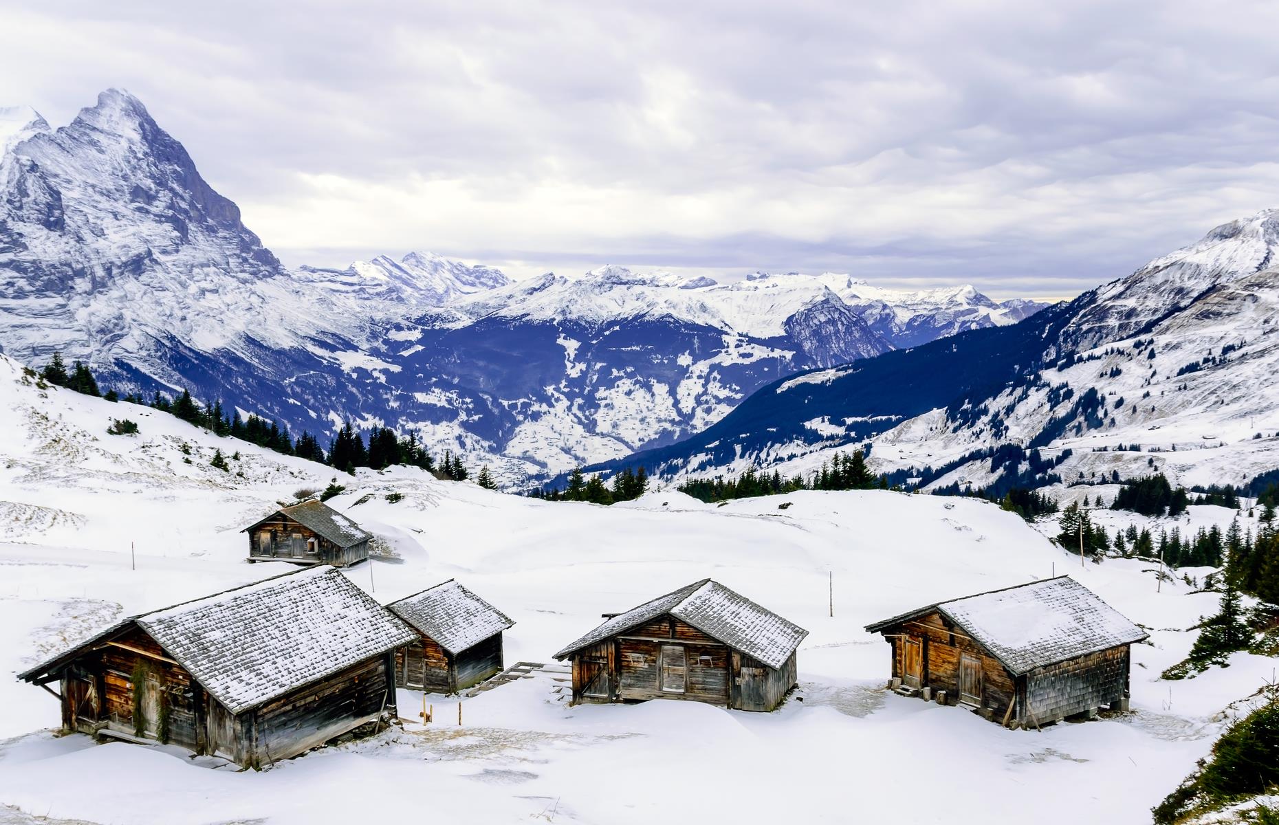 Surrounded by the regal-looking Jungfrau, Mönch and Eiger mountains, the ski village of Grindelwald oozes with alpine charm. It began life as a ski resort from the end of the 18th century and today remains a small yet thriving destination with quaint lodges, mountaintop restaurants and cozy pubs. The village is beautiful year-round: by summer, its steep slopes are plastered in verdant green; by winter, it’s shrouded in a blanket of snow.