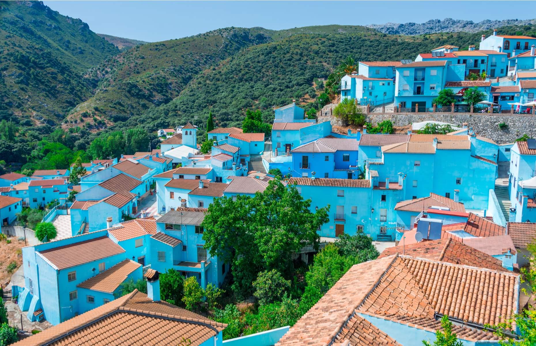 <p>There’s a fascinating story behind Júzcar’s bright blue buildings. In 2011, residents of the Andalusian village were approached by Sony Pictures, who requested to paint its whitewashed houses blue as a marketing ploy for <em>The Smurfs</em> movie. After some initial concerns, they agreed and the entire place was turned Smurf-blue. However, the following year, when Sony attempted to revert the village to its original white, locals refused as the Smurf connection had led to an explosion in tourism. </p>