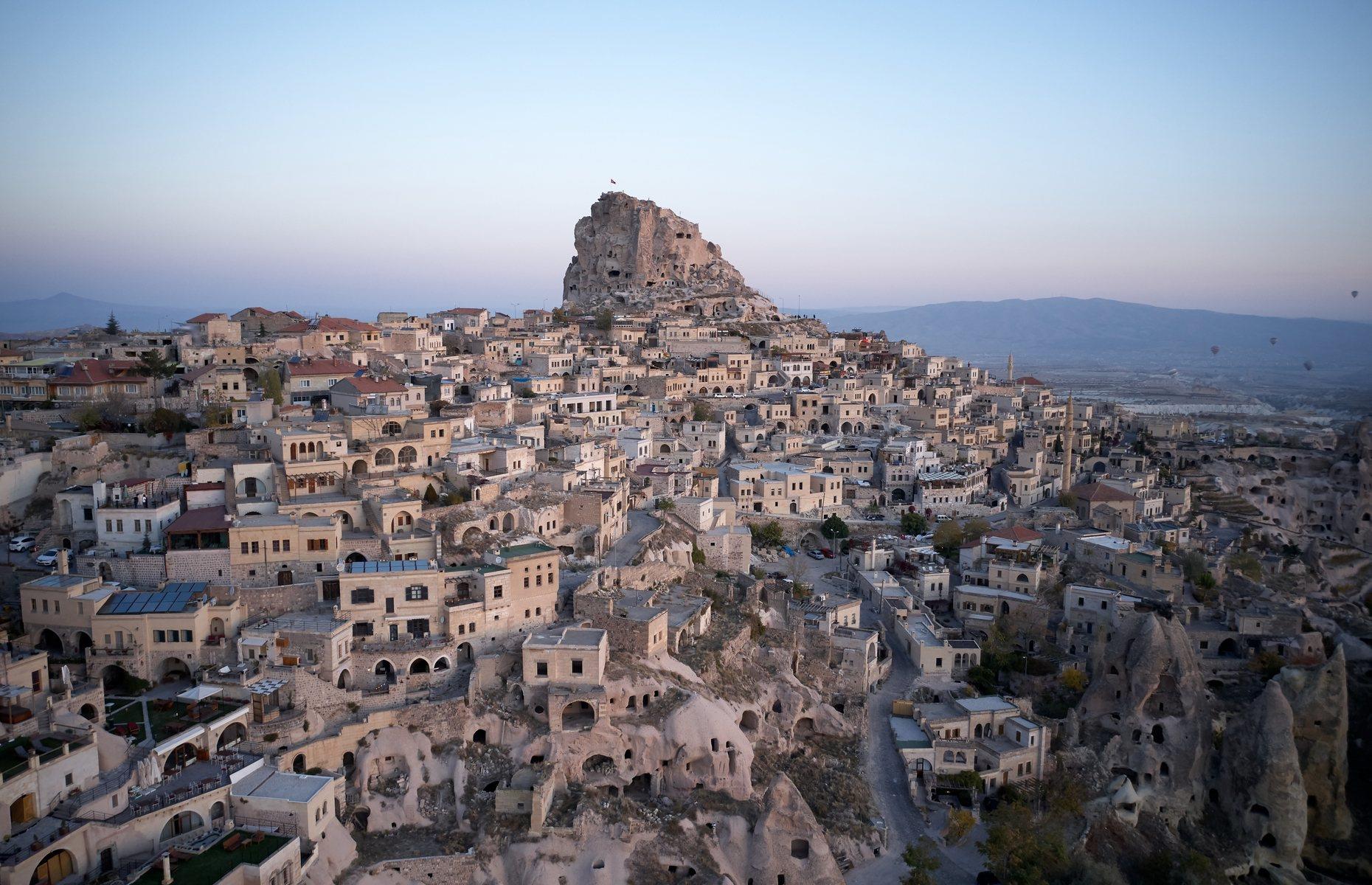 There’s something otherworldly about Ortahisar, a rustic town located in Turkey’s Cappadocia region. Its best-known feature is the historic fortress, built onto one of the region’s iconic “fairy chimneys” (rock columns), which has steadily eroded away during the past few centuries. Besides this, Ortahisar’s patchwork of stone houses and caves, melding seamlessly with the rock face, have an almost model-village feel.