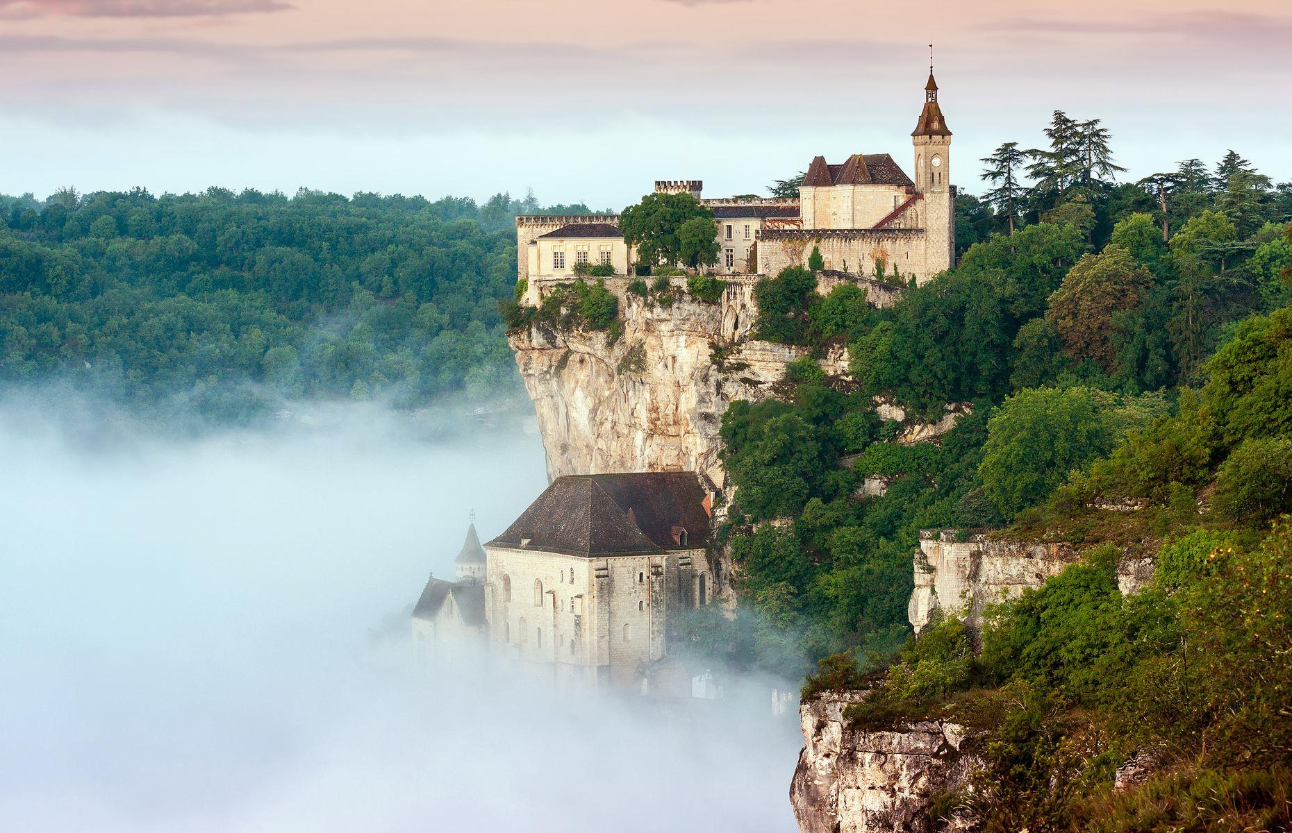 <p>The clifftop town of Rocamadour looks especially enchanting in this cloud-draped shot. Crowned by a 14th-century château, it comprises a cluster of historic buildings clinging to the cliffs at varying levels above the gorge of the Alzou River. The UNESCO World Heritage Site started life as a hermitage for Saint Amadour in the 12th century, and for the next 300 years it served as a popular pilgrimage location, during which time a number of important religious buildings and fortifications were added.</p>