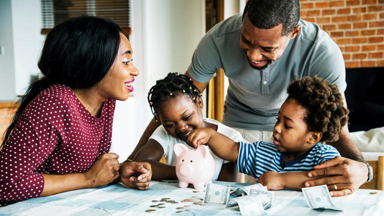 Family saving money to piggy bank