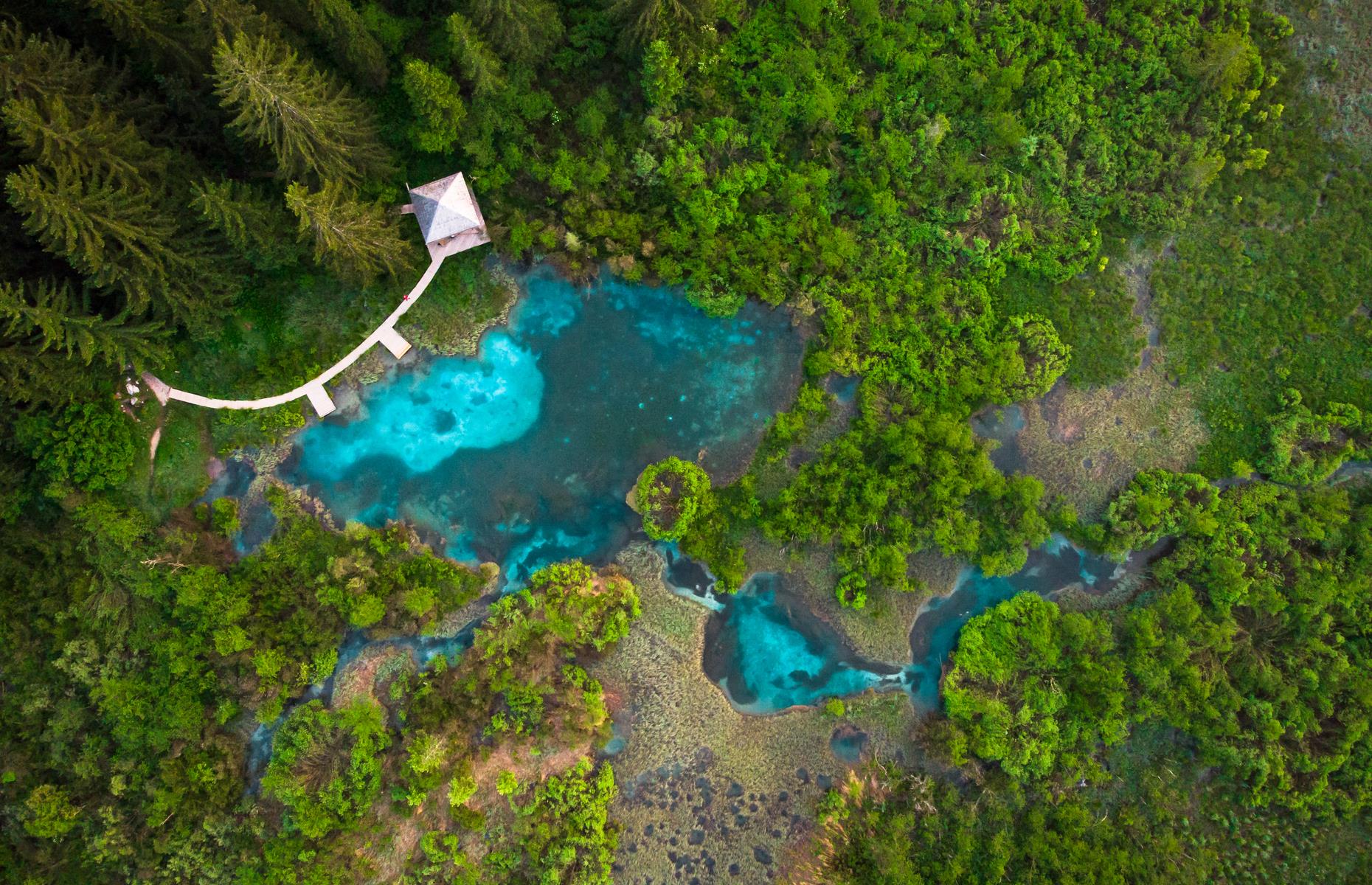 With its striking bright blue waters surrounded by lush green forest, Zelenci Lake is an impressive sight from above. Located in Zelenci Nature Reserve in northwestern Slovenia, the lake's striking color comes from a natural spring that flows through the layers of sedimentary rock below.