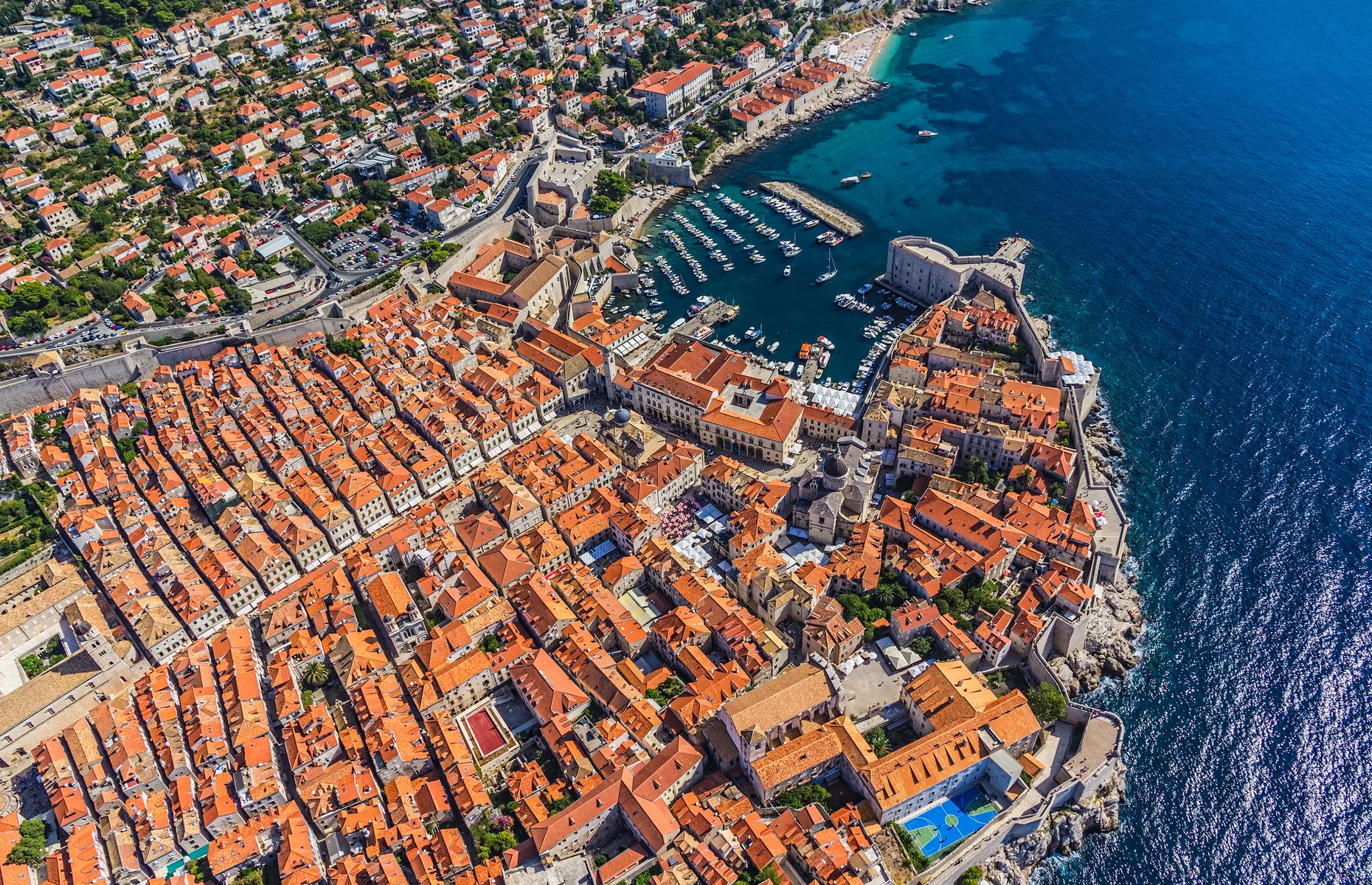 <p>The medieval walled city of <a href="https://www.loveexploring.com/news/92374/things-to-do-in-dubrovnik-game-of-thrones-dubrovnik-holidays-croatia">Dubrovnik</a> has earned film star status thanks to its appearance in movies and TV series including <em>Game of Thrones</em>, but it doesn’t need duels and dragons to bring it to life. Captured from above in this awe-inspiring shot, with its patchwork of terracotta buildings cradled by ancient limestone walls, the city looks as though it’s been plucked straight from a fantasy book. </p>