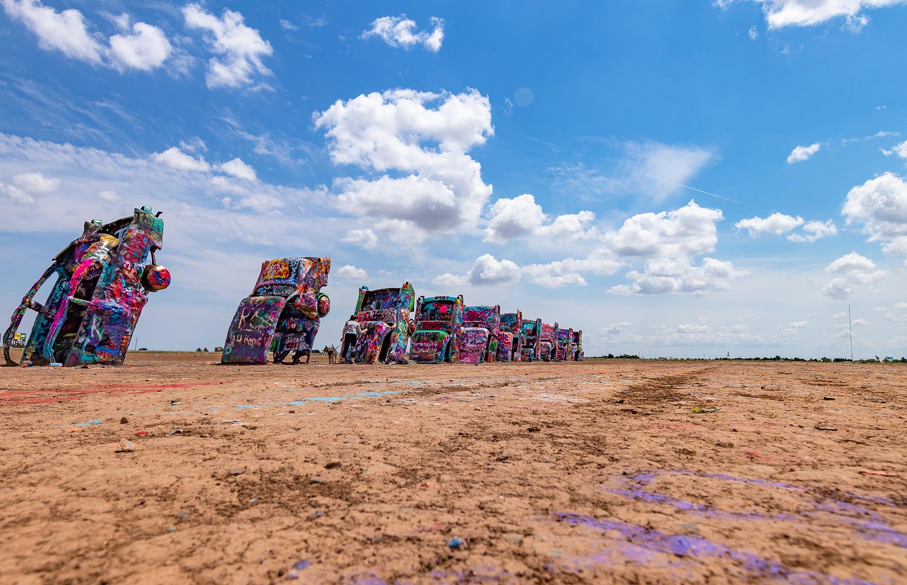 <p>Fun and sometimes bizarre roadside attractions are huge in the US and Texas sure does have some of the best. Cadillac Ranch, just outside of Amarillo in northern Texas, is an art installation that consists of a series of upturned cars painted in bright colors and psychedelic-like patterns. Installed in 1974, using 10 junk Cadillacs, it's now become a popular tourist attraction in this area.</p>  <p><strong><a href="https://www.loveexploring.com/gallerylist/65669/32-unusual-things-youll-find-on-a-road-trip-through-the-usa">Here are more unusual things you'll find on a road trip through the USA</a></strong></p>