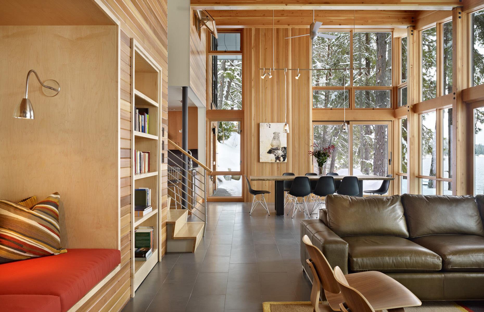<p>This rustic yet modern living room looks just like any luxury living space with its floor-to-ceiling windows and soaring ceilings. However, <a href="https://www.deforestarchitects.com/">DeForest Architects</a> gave the room a secret door. Can you spot it? </p>