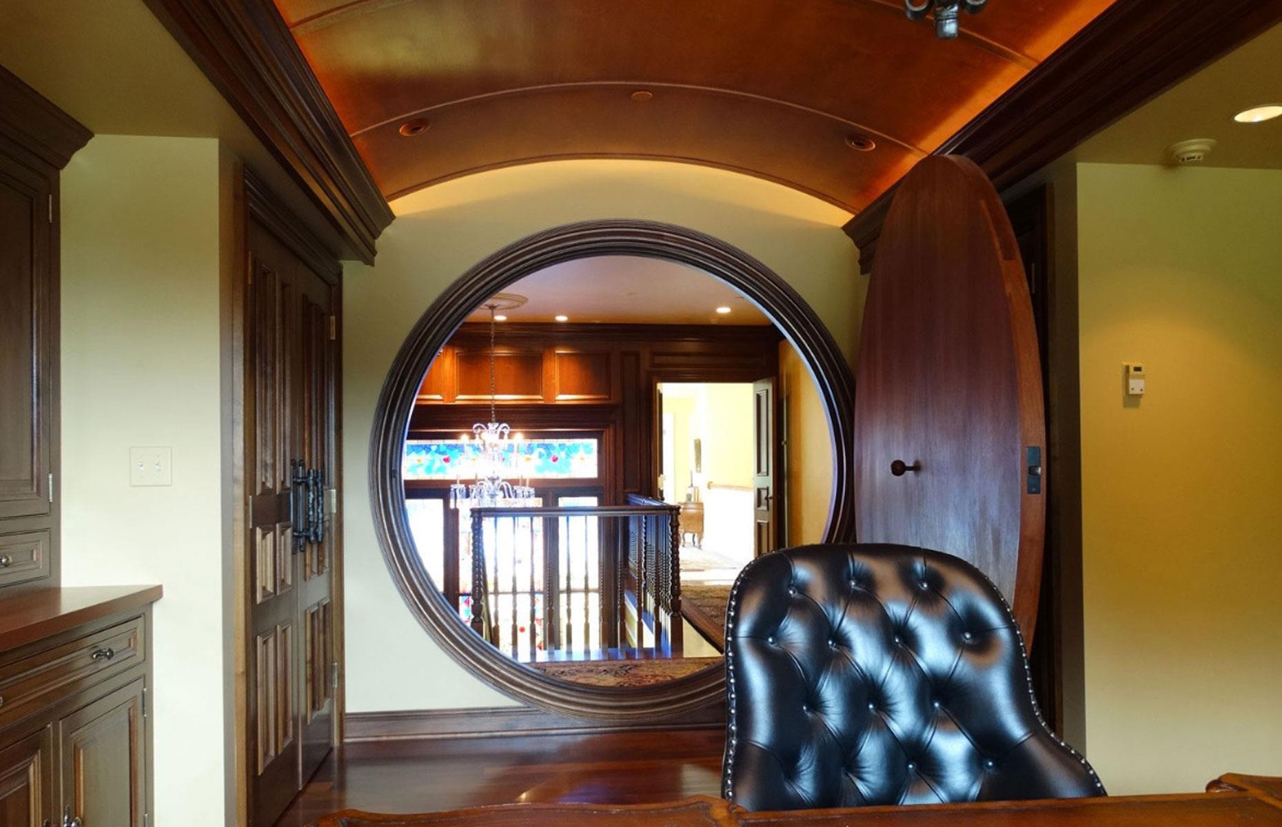 <p>A unique feature, the magnificent solid wooden hidden door was commissioned by the former owner, a diehard Tolkien fan, who spent a fortune having it custom-made and installed in the luxurious mansion to resemble a <a href="https://www.loveproperty.com/gallerylist/62633/real-life-hobbit-homes-that-put-the-shire-to-shame">real-life hobbit home</a>. </p>