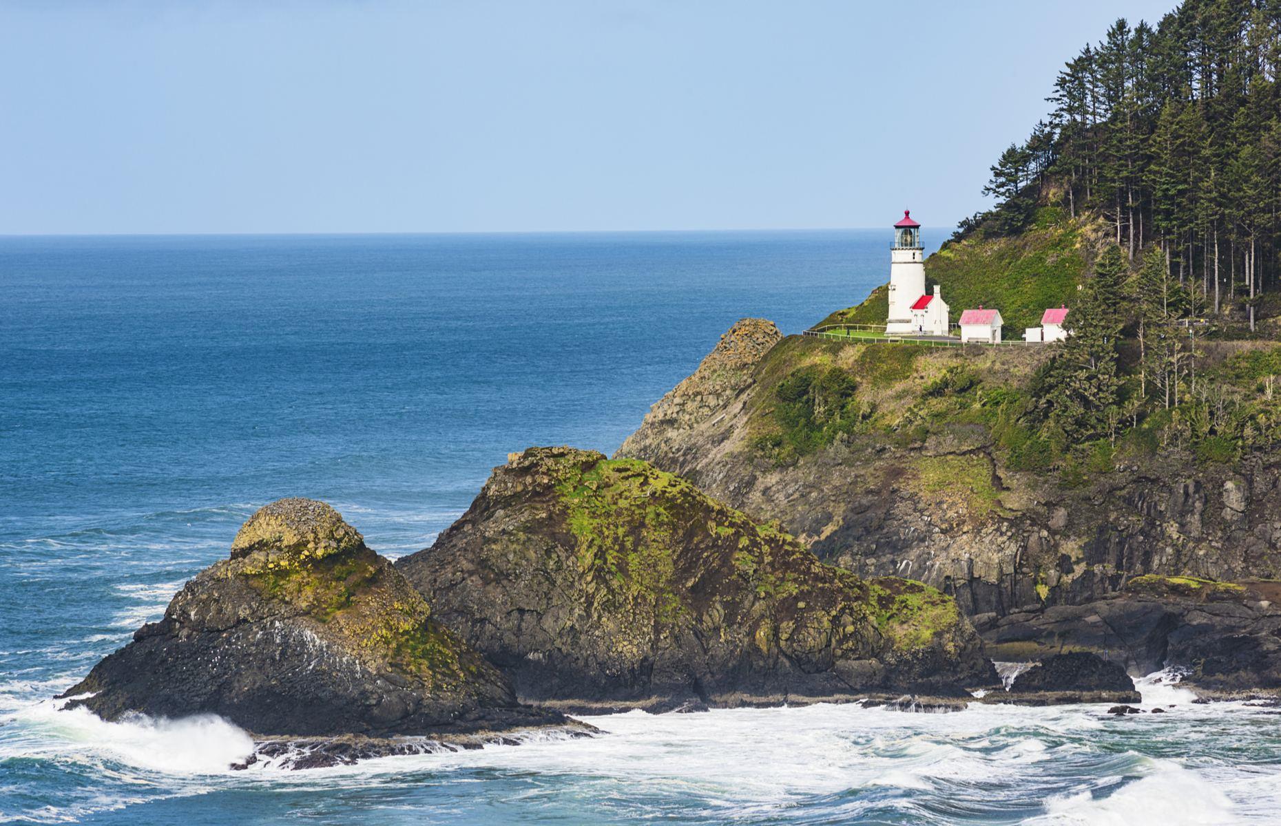 <p>The quaint Heceta Head Light is situated about halfway along Oregan's coastline and stands on an impressive 1,000-foot (305m) tall bluff above the crashing Pacific Ocean. The lighthouse was first lit in 1894 and it’s still guiding mariners to this day, using an automated light which is the most powerful rated on Oregon's coast. The keeper's cottage has been transformed into a B&B which offers unbeatable views of the cliffs and beach below too. </p>