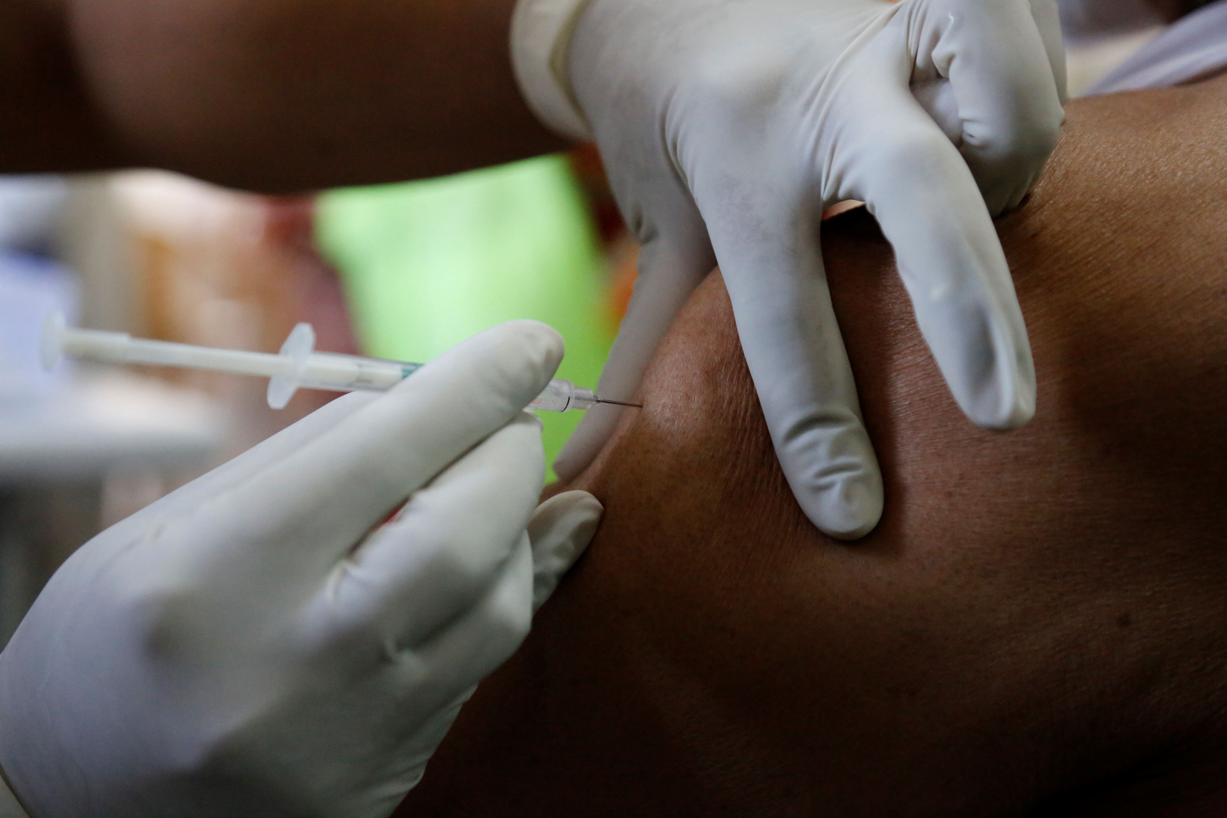 A man receives a shot of the Covishield COVID-19 vaccine at Sola Civil hospital in Ahmedabad, India, Wednesday, March 3, 2021. The COVID-19 vaccination drive for senior citizens and those above 45 years of age with comorbidities began in government and designated private hospitals in Gujarat on Monday along with the rest of the country. (AP Photo/Ajit Solanki)