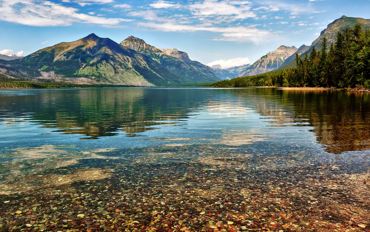 <p>As the largest lake in Montana's photogenic Glacier National Park, <a href="http://www.visitmt.com/listings/general/lake/lake-mcdonald.html">Lake McDonald</a> spans 10 miles and sinks 472 feet deep. Formed by Ice Age-era glaciers, the lake has a still, reflective surface that provides the perfect mirror for the surrounding mountains. Visitors might even spot a bighorn sheep, elk, or black bear, as they are known to tour the area.</p>