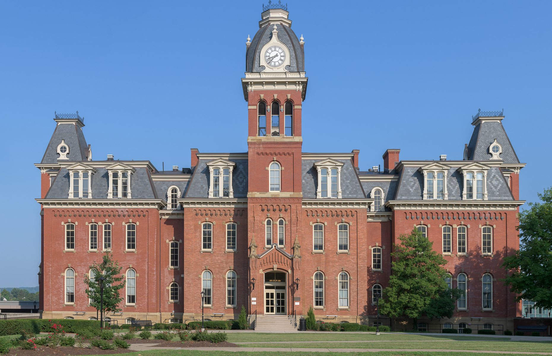 <p>The clock tower, slate mansard roof, arched dormer windows, and red brick are all iconic features of Woodburn Hall (pictured), the gorgeous Second Empire–style building on <a href="https://www.wvu.edu/" rel="noreferrer noopener">West Virginia University</a>’s Morgantown campus. The Hall is one of three buildings on Woodburn Circle, listed on the National Register of Historic Places.</p>
