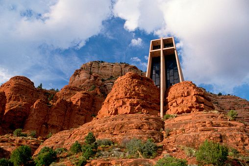 <p>No matter what belief system you subscribe to, it would be hard not to have a spiritual experience while gazing out of the stained glass windows of the <a href="https://www.gatewaytosedona.com/the-chapel-of-the-holy-cross-sedona-architectural-landmark">Chapel of the Holy Cross</a> in <a href="https://go.redirectingat.com?id=74968X1553576&url=https%3A%2F%2Fwww.tripadvisor.com%2FTourism-g31352-Sedona_Arizona-Vacations.html&sref=https%3A%2F%2Fwww.housebeautiful.com%2Flifestyle%2Fg25905868%2Funusual-buildings-in-america%2F">Sedona, Arizona</a>. Marked by a 90-foot cross and nestled among the red rocks nearly 200 feet above ground level, it was the Empire State Building that inspired sculptor Marguerite Brunswig Staude to build the cathedral, completed in 1955.</p>