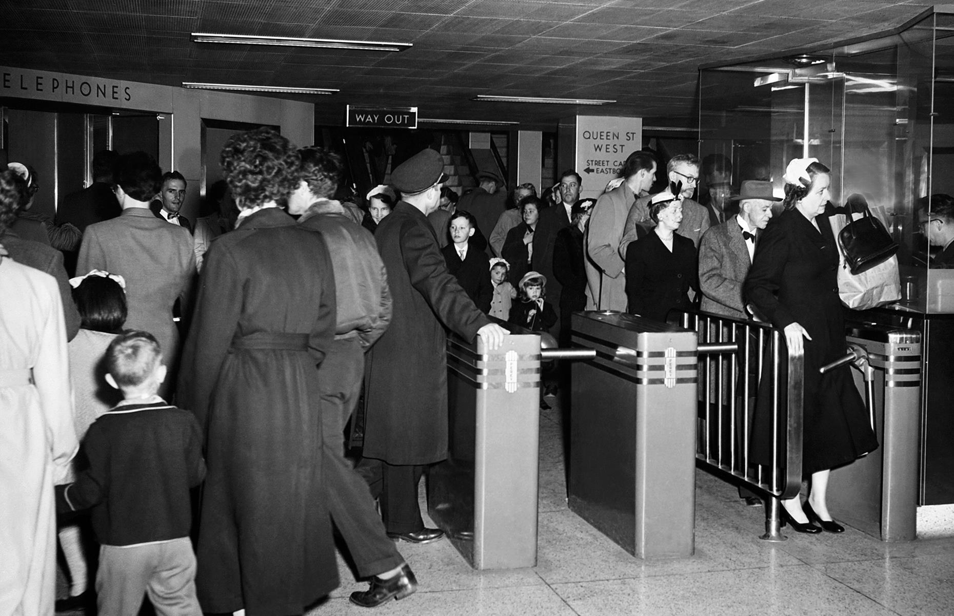 Canada's most populous city followed in the tracks of its North American sisters when its subway launched in 1954. This photo dates to 1957 and shows a busy scene at the city's Queen Street station, as passengers pass through the turnstiles.