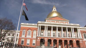 a large building with Massachusetts State House in the background