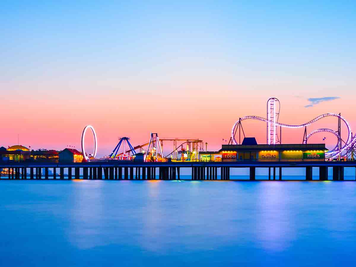 <p>If you’re longing for a Coney Island, Santa Monica, or Chicago Navy Pier experience, look no further than Galveston Island Historic Pleasure Pier. This hot spot features waterfront fun and entertainment like no other Gulf Coast destination. The Galveston Island Historic Pleasure Pier has family-oriented attractions including rides, midway games, a wide selection of food venues, and retail shops.</p>  <p>The pier had its origin as a recreational facility for the US Military during WWII as one of the largest dance floors of its kind. Hurricane Carla swept it away and a new pier was built. Today, rides reach out over the Gulf of Mexico that include coasters, water rides, a carousel, and a wonderous Galaxy Wheel. Multiple shops and dining options like Rainforest Café, Fish Tales, and Saltgrass Steakhouse line the pier for an all-inclusive experience.</p>
