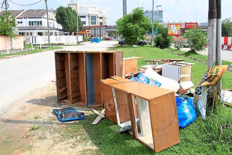 Old furniture dumped along a road in Subang Jaya. The service is aimed at stopping this practice. — Filepic