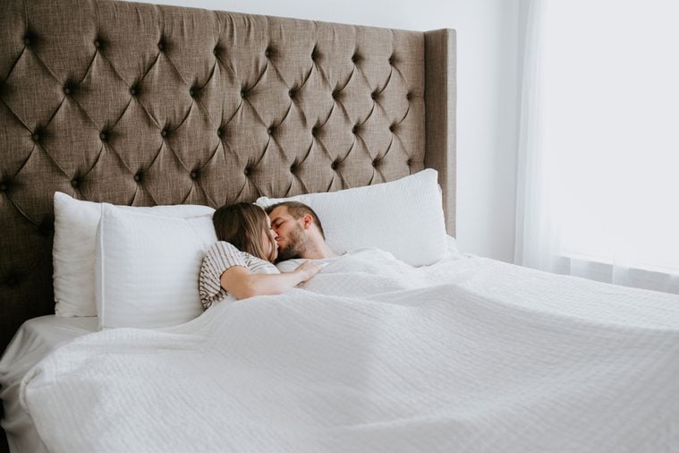 Happy Couple in Cuddling in Bed
