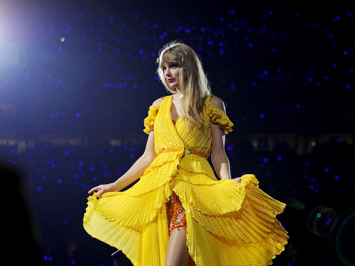 <p>During her acoustic set (where she performs two surprise songs), Taylor covers her sequined Roberto Cavalli 1989 outfit and Christian Louboutin boots with this stunning yellow dress. </p>